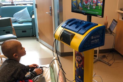 Boy Playing on Gaming Station