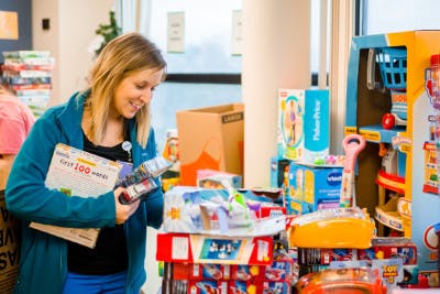 Children's of Mississippi child life specialist Tiffany Key in hospital looking through a pile of games and toys